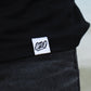 Close up of hem tag on black shirt.